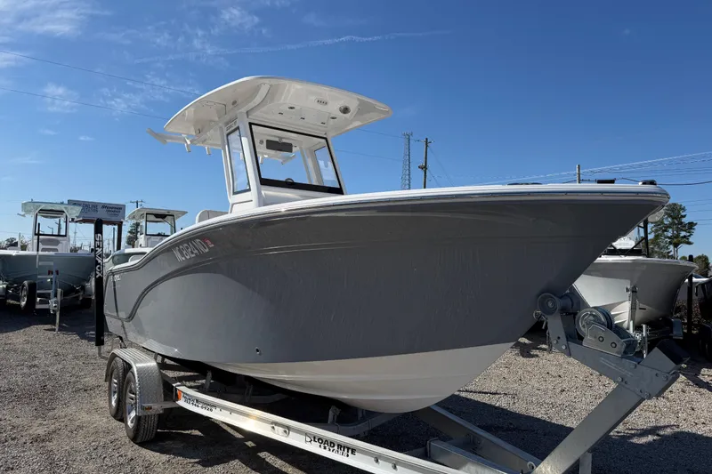 Slide: The Image of 2025 Sea Fox 228 Commander boat on trailer under clear blue sky. - 2