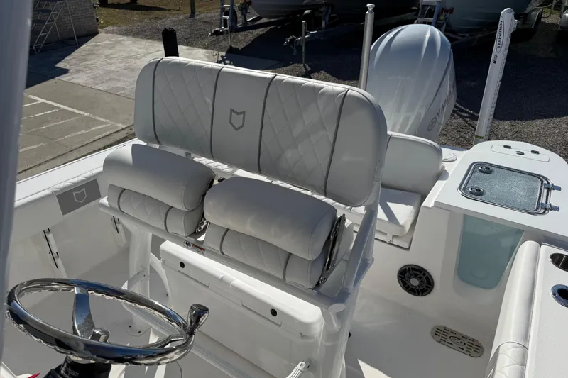 Slide: The Image of 2025 Sea Fox 228 Commander boat interior with cushioned seating and steering wheel. - 21