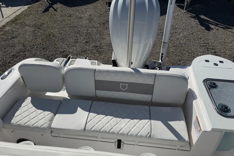 Slide: The Image of 2025 Sea Fox 228 Commander boat with cushioned seating and outboard motor. - 24