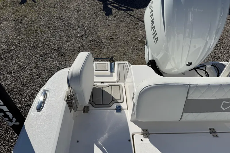 Slide: The Image of 2025 Sea Fox 228 Commander boat interior with Yamaha engine, featuring white seating and deck. - 31