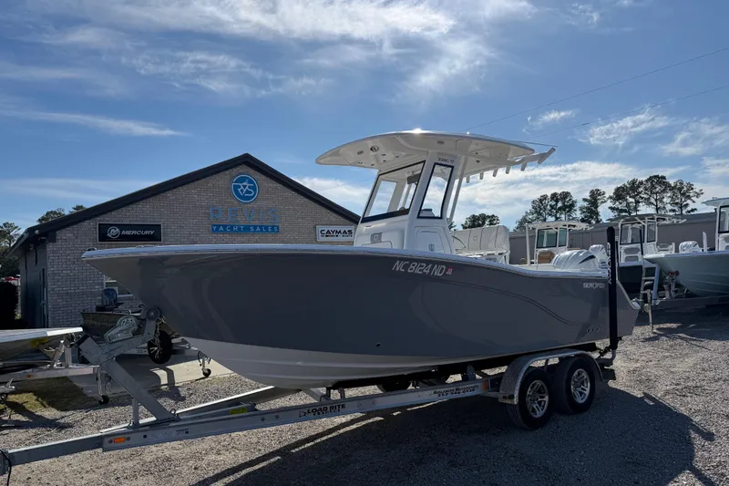 Slide: The Image of 2025 Sea Fox 228 Commander boat on trailer at dealership under blue sky. - 4