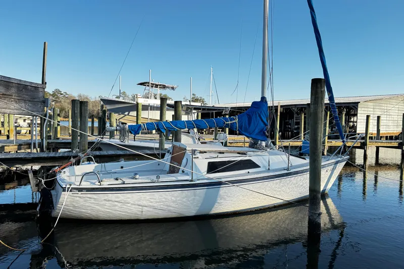 Slide: The Image of 1984 O'Day 222 sailboat docked at marina, blue sky background. - 11