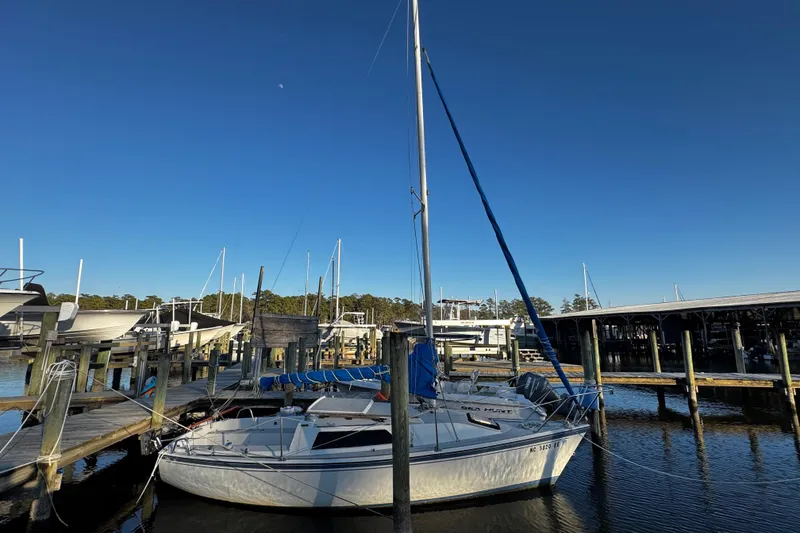 Slide: The Image of 1984 O'Day 222 sailboat docked at marina under clear blue sky. - 12