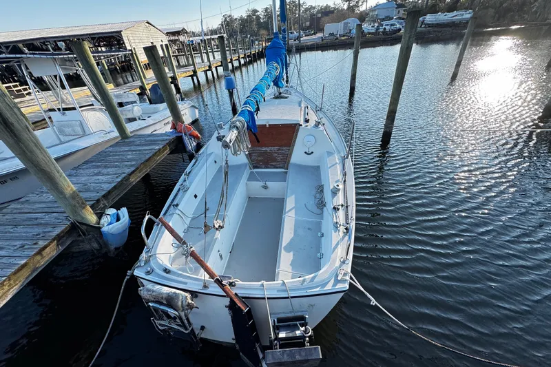 Slide: The Image of 1984 O'Day 222 sailboat docked at a marina, surrounded by calm water. - 13