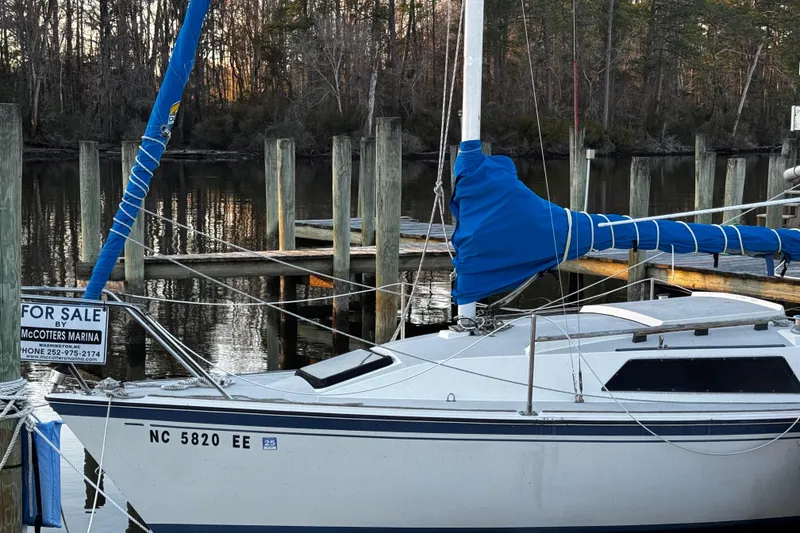 Slide: The Image of 1984 O'Day 222 sailboat for sale at McCotters Marina, docked by wooded shoreline. - 21
