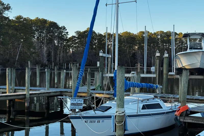 Slide: The Image of 1984 O'Day 222 sailboat for sale at marina dock, surrounded by trees. - 22
