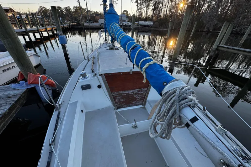 Slide: The Image of 1984 O'Day 222 sailboat docked at marina, sunset reflecting on water. - 28