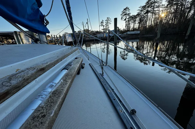 Slide: The Image of 1984 O'Day 222 sailboat docked at serene marina during sunset. - 31