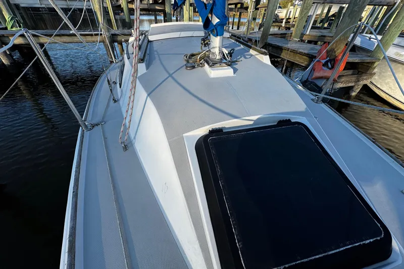 Slide: The Image of 1984 O'Day 222 sailboat deck view at marina, featuring rigging and hatch. - 36