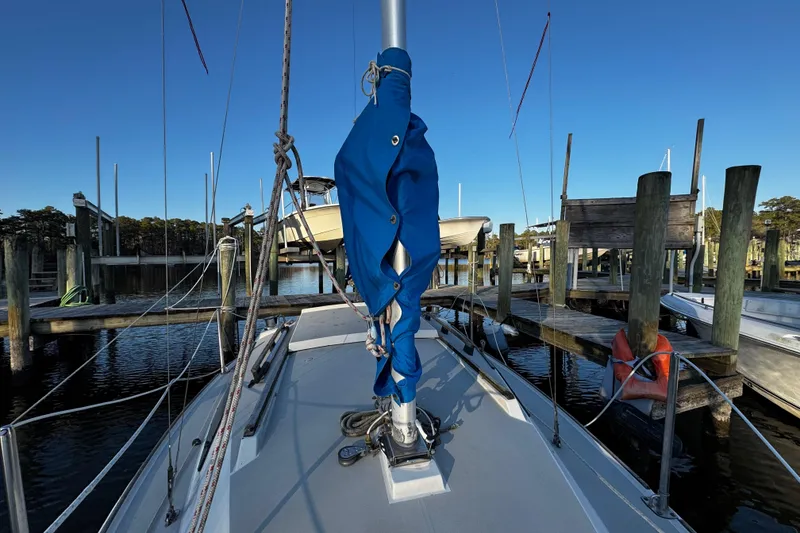 Slide: The Image of 1984 O'Day 222 sailboat docked at marina, blue sail cover, clear sky. - 38