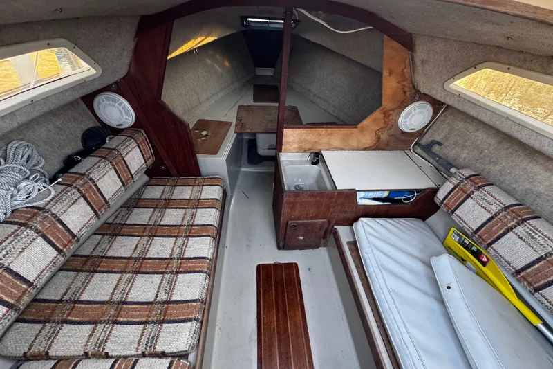 Slide: The Image of 1984 O'Day 222 sailboat interior with plaid seating and compact cabin layout. - 40