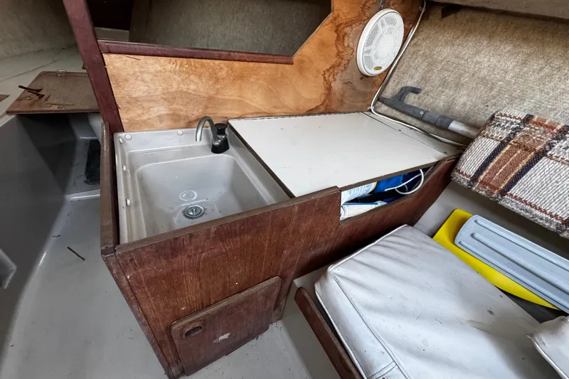 Slide: The Image of 1984 O'Day 222 sailboat interior with sink and storage area. - 43