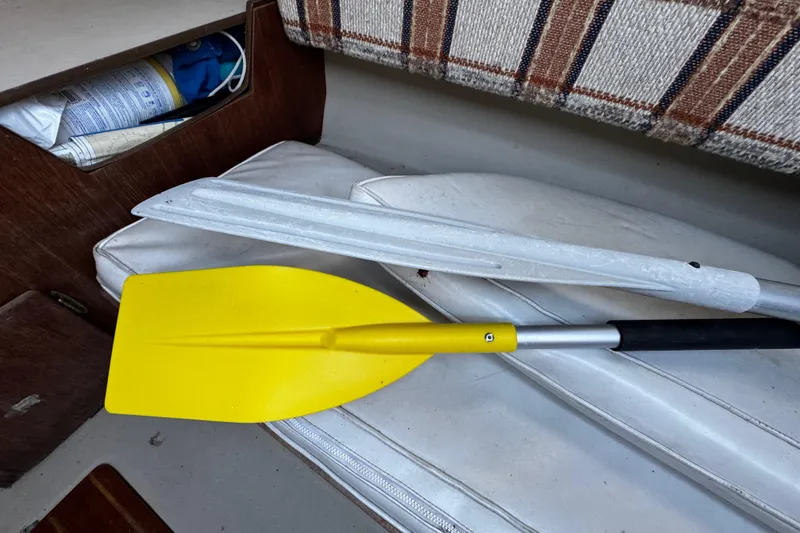 Slide: The Image of Yellow paddle and white oar inside 1984 O'Day 222 sailboat cabin. - 44