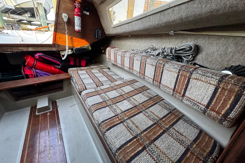 Slide: The Image of Interior of 1984 O'Day 222 sailboat with plaid cushions and safety equipment. - 45