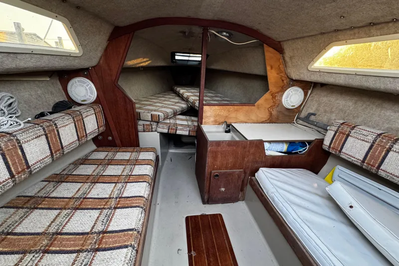 Slide: The Image of 1984 O'Day 222 sailboat interior with plaid seating and compact cabin layout. - 47