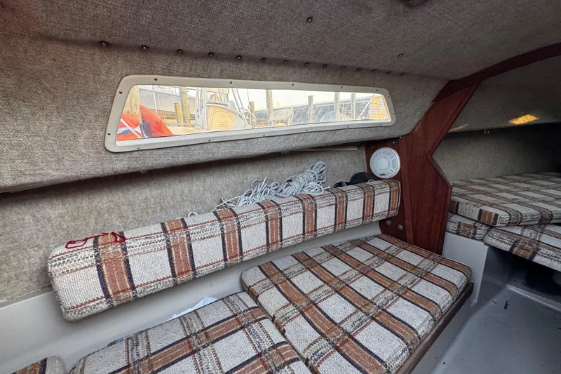 Slide: The Image of Interior of 1984 O'Day 222 sailboat with plaid cushions and window view. - 48