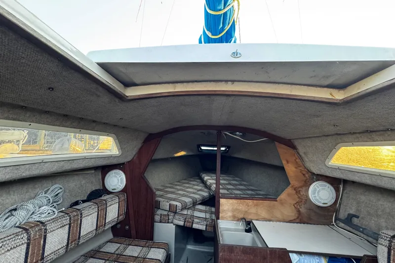 Slide: The Image of Interior of a 1984 O'Day 222 sailboat with plaid cushions and compact cabin layout. - 49