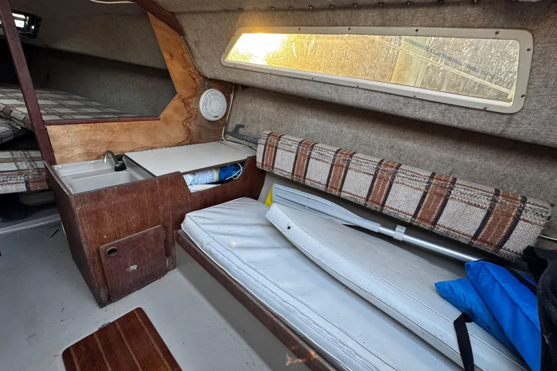 Slide: The Image of 1984 O'Day 222 sailboat interior with seating, sink, and storage. - 50