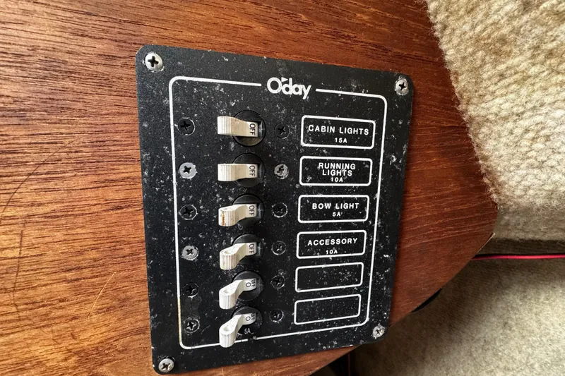 Slide: The Image of Control panel of a 1984 O'Day 222 sailboat with labeled switches. - 53