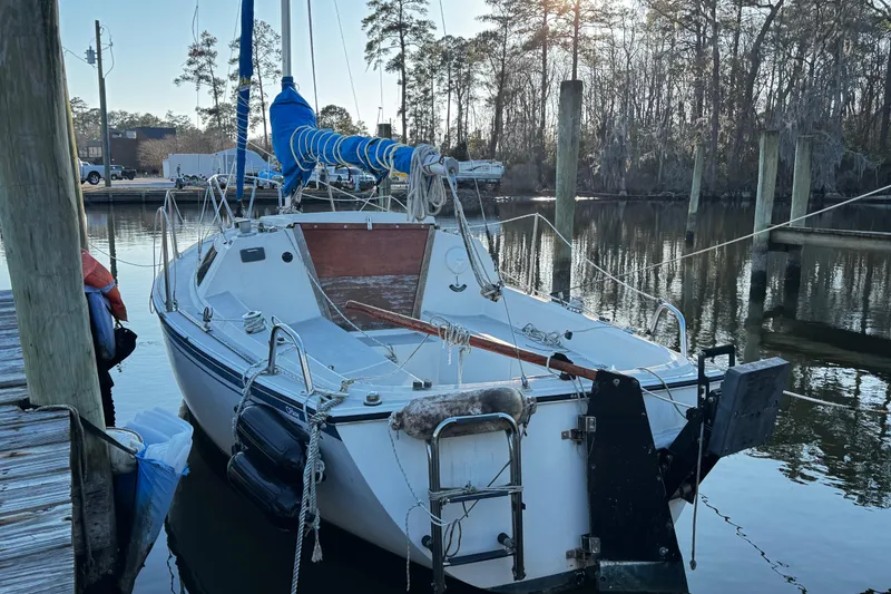 Slide: The Image of 1984 O'Day 222 sailboat docked in a serene marina setting. - 6