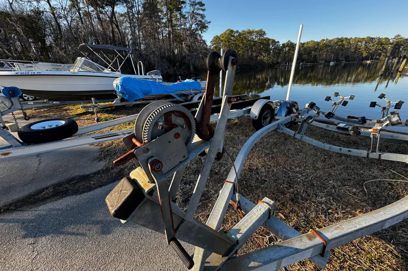 Slide: The Image of Boat trailer with winch near water, featuring an O'Day 222 sailboat, 1984 model. - 60