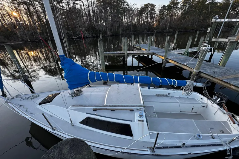 Slide: The Image of 1984 O'Day 222 sailboat docked peacefully at sunset. - 9