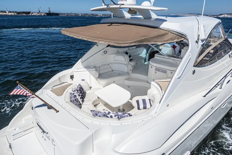 Slide: The Image of 2004 Cruisers Yachts 540 Express on water, featuring spacious deck and seating area. - 11