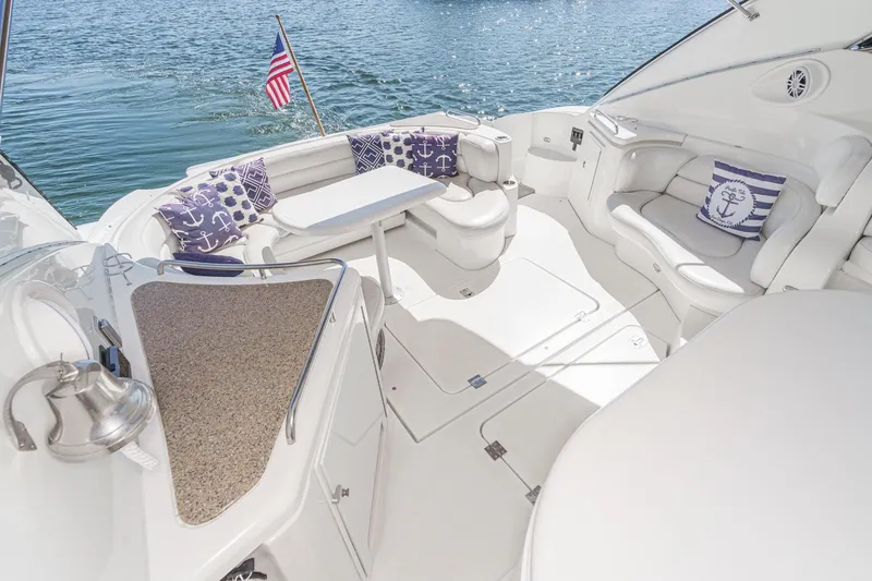 Slide: The Image of Luxurious 2004 Cruisers Yachts 540 Express interior with nautical-themed cushions and elegant seating. - 14