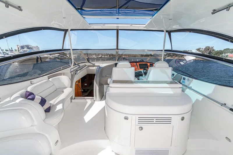 Slide: The Image of Luxurious interior of 2004 Cruisers Yachts 540 Express with panoramic windows and plush seating. - 18