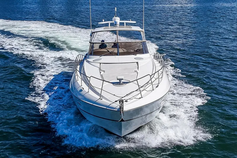 Slide: The Image of 2004 Cruisers Yachts 540 Express cruising on open water, front view. - 2