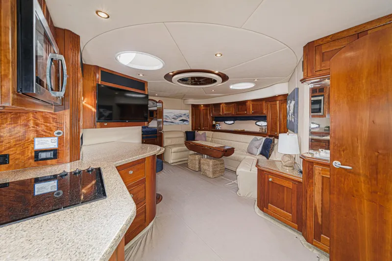 Slide: The Image of Luxurious interior of 2004 Cruisers Yachts 540 Express with elegant wood finishes and modern amenities. - 27