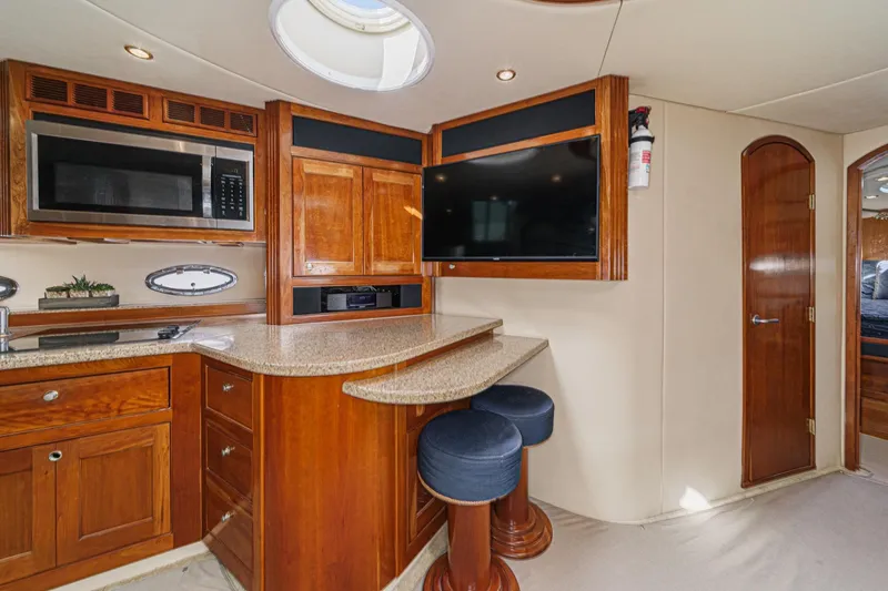 Slide: The Image of Luxurious 2004 Cruisers Yachts 540 Express interior with modern kitchen and seating area. - 32