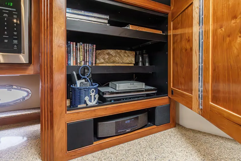 Slide: The Image of Entertainment cabinet in 2004 Cruisers Yachts 540 Express with electronics and DVDs. - 33
