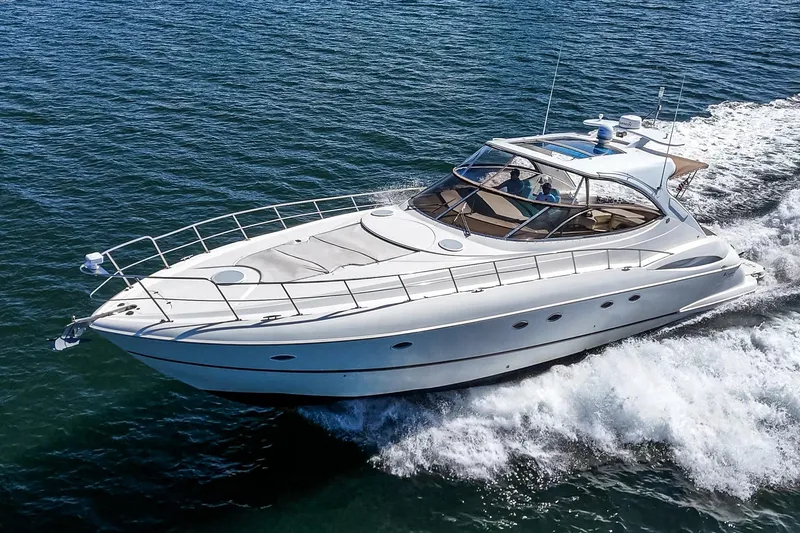 Slide: The Image of 2004 Cruisers Yachts 540 Express cruising on open water, showcasing sleek design and luxury. - 4