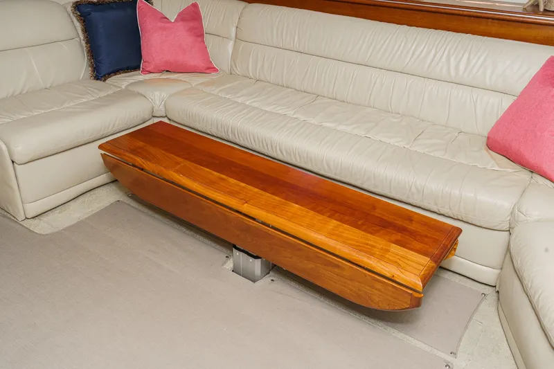 Slide: The Image of Luxurious 2004 Cruisers Yachts 540 Express interior with leather seating and wooden table. - 41