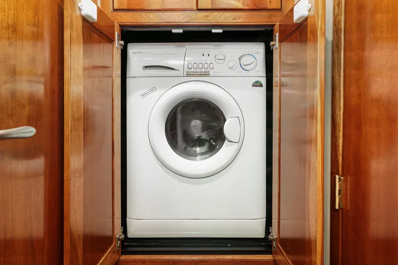 Slide: The Image of Washing machine inside wooden cabinet on 2004 Cruisers Yachts 540 Express. - 57