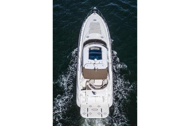 Slide: The Image of 2004 Cruisers Yachts 540 Express cruising on open water, aerial view. - 7