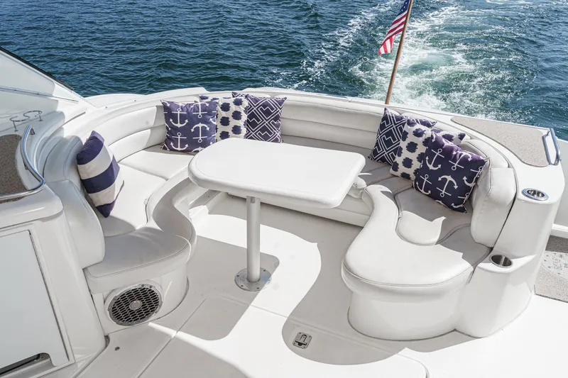 Slide: The Image of Luxurious 2004 Cruisers Yachts 540 Express with elegant seating and nautical-themed cushions. - 15