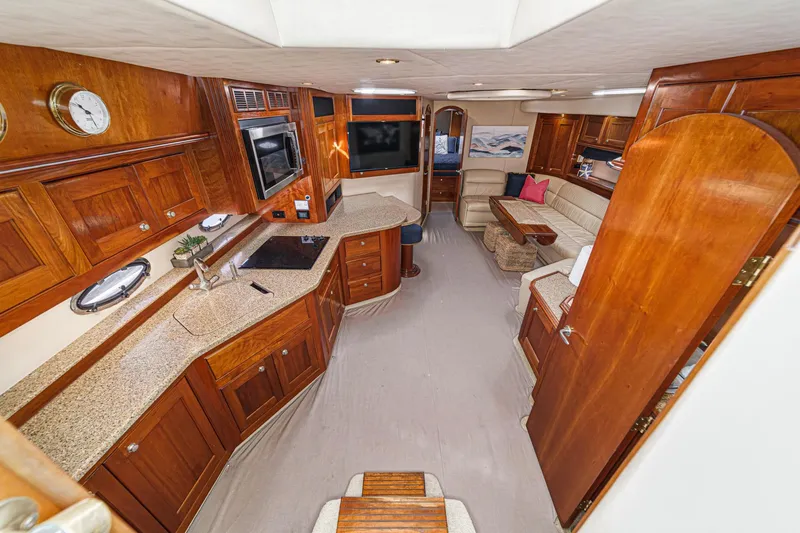 Slide: The Image of Luxurious interior of 2004 Cruisers Yachts 540 Express with elegant wood cabinetry and modern amenities. - 25