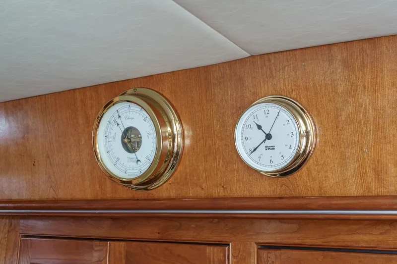 Slide: The Image of Gold-trimmed barometer and clock on 2004 Cruisers Yachts 540 Express wooden interior. - 30
