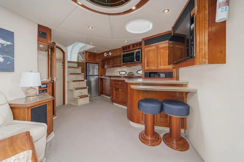 Slide: The Image of Luxurious interior of 2004 Cruisers Yachts 540 Express with elegant wood cabinetry and modern amenities. - 36