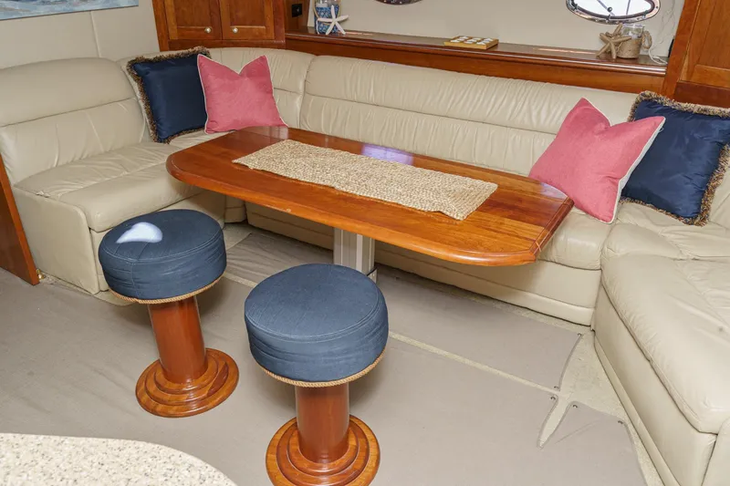 Slide: The Image of Luxurious 2004 Cruisers Yachts 540 Express interior with elegant seating and wooden table. - 40