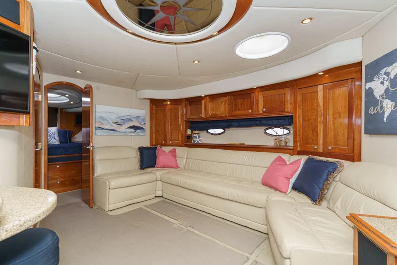 Slide: The Image of Luxurious 2004 Cruisers Yachts 540 Express interior with elegant seating and wood cabinetry. - 43