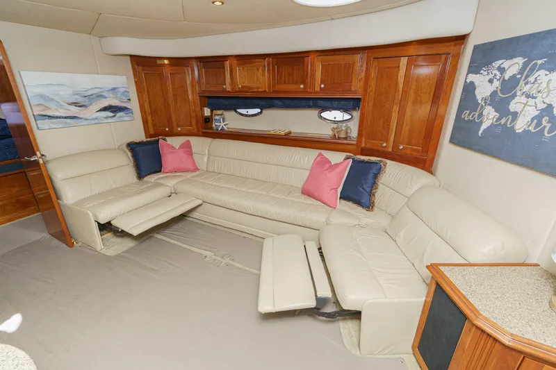 Slide: The Image of Luxurious 2004 Cruisers Yachts 540 Express interior with plush seating and elegant wood cabinetry. - 48