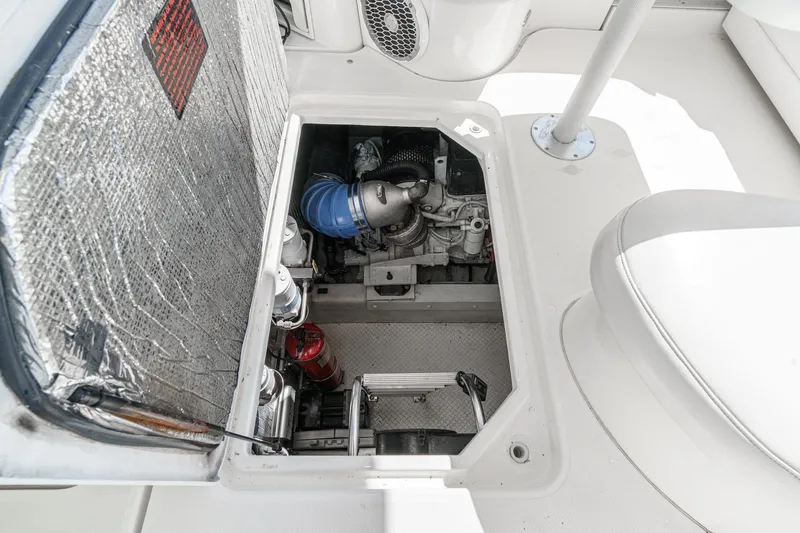 Slide: The Image of Engine compartment of 2004 Cruisers Yachts 540 Express, showcasing mechanical components and insulation. - 58