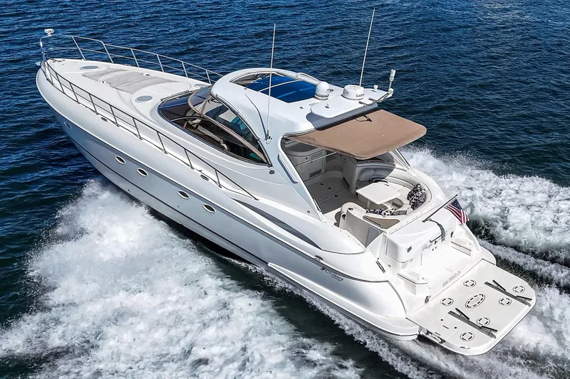 Slide: The Image of 2004 Cruisers Yachts 540 Express cruising on open water, showcasing sleek design and luxury. - 6