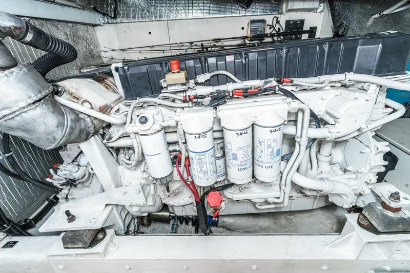 Slide: The Image of Engine compartment of 2004 Cruisers Yachts 540 Express, showcasing detailed mechanical components. - 62