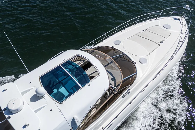 Slide: The Image of 2004 Cruisers Yachts 540 Express cruising on open water, aerial view. - 8