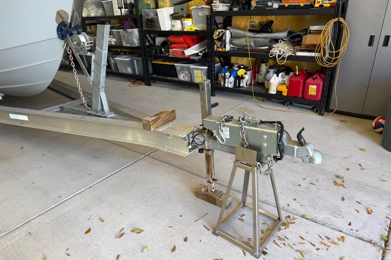 Slide: The Image of Trailer hitch setup for 2022 Parker 2501 Center Console boat in a garage. - 10