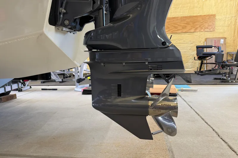 Slide: The Image of 2022 Parker 2501 Center Console boat with Yamaha outboard motor in a garage. - 13